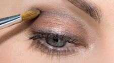 Apply Black Diamond eyeshadow into the socket line of the eye and also above the top lashes, and below the bottom lashes. Sweep White Gold eyeshadow below your eyebrow.